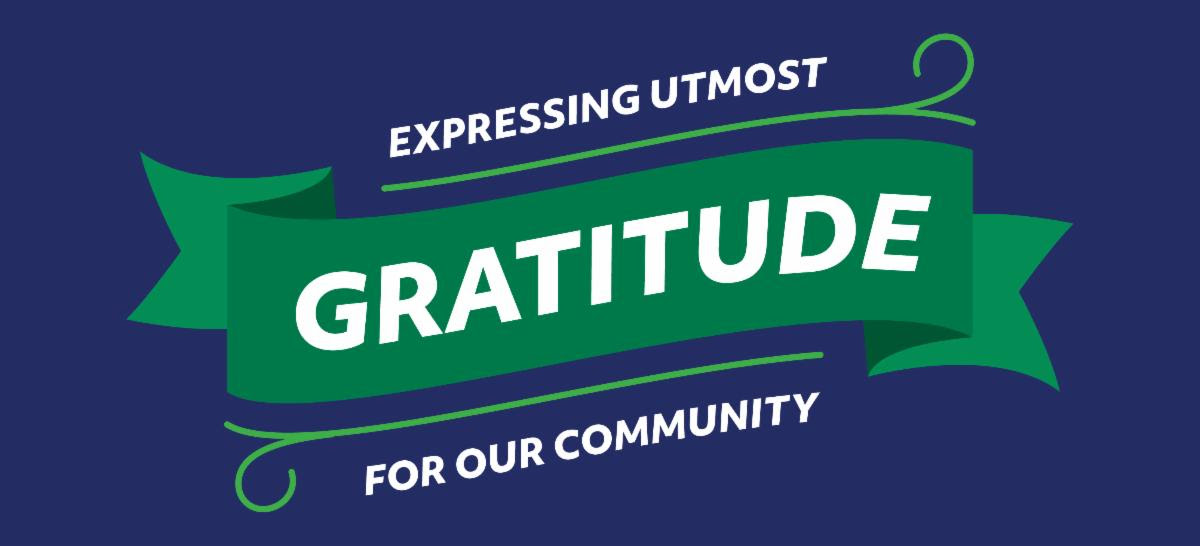A navy background with text reading expressing utmost gratitude for our community in white text with a green ribbon behind it