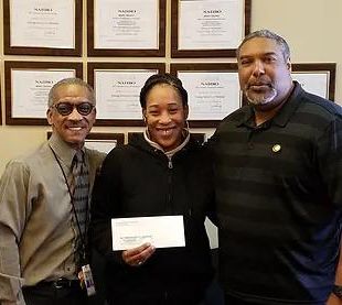 photo of Clyde Hare, 2018 FSS Graduate Maria Allen holding a paper up, and Randy Wood