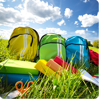 backpacks in the open grass