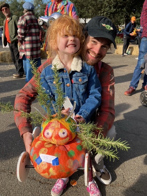 child and dad with pumpkin