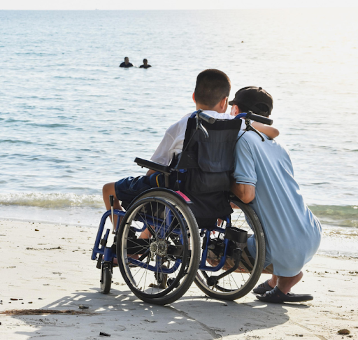 Aloïs and Calixte De Bourne hugging on the beach