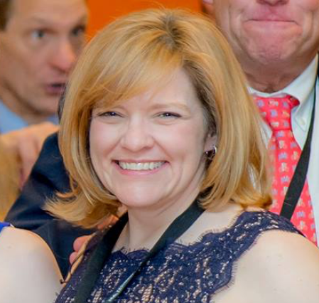 White woman with short blonde hair and bangs