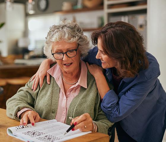 older woman and a younger woman looking at a piece of paper