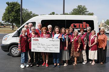 group of people standing in front of a van