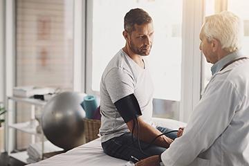 doctor taking a patient's blood pressure