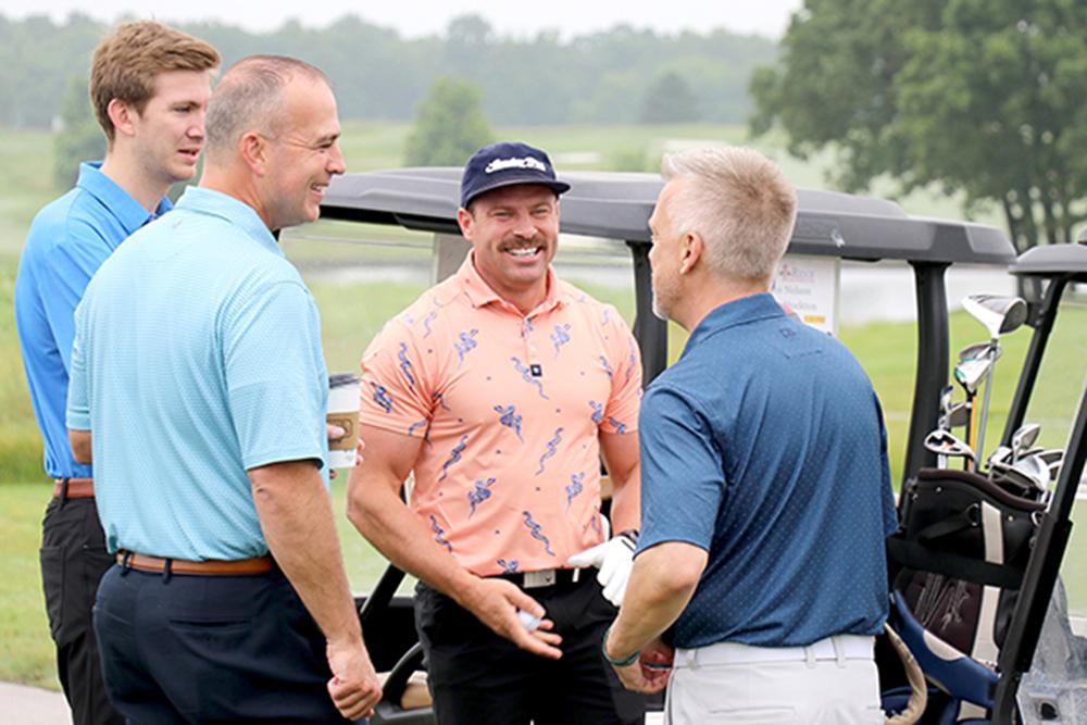 four people on a golf course