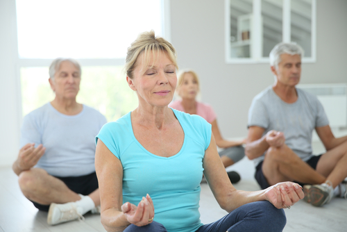 Group of senior people doing yoga exercises
