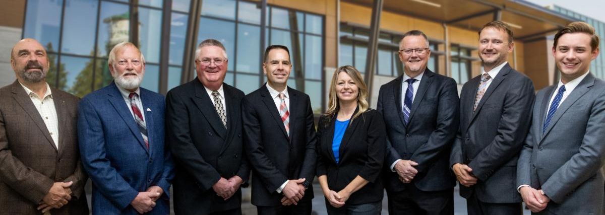 Photo shows current councilmembers standing side by side for a group photo; L-R: Councilmembers Steve Muller, Tom King, Kelly Richards; Mayor Jon Nehring; Councilmembers Kamille Norton, Mark James; Council President Michael Stevens; Councilmember Peter Condyles.