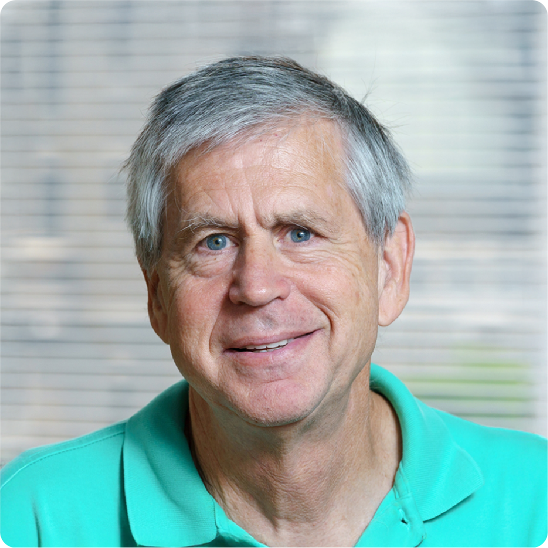 A color photo of a man smiling for a photo