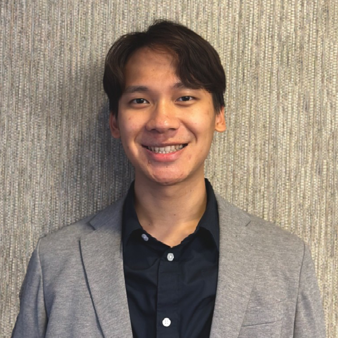 A color photo of a man smiling for a photo