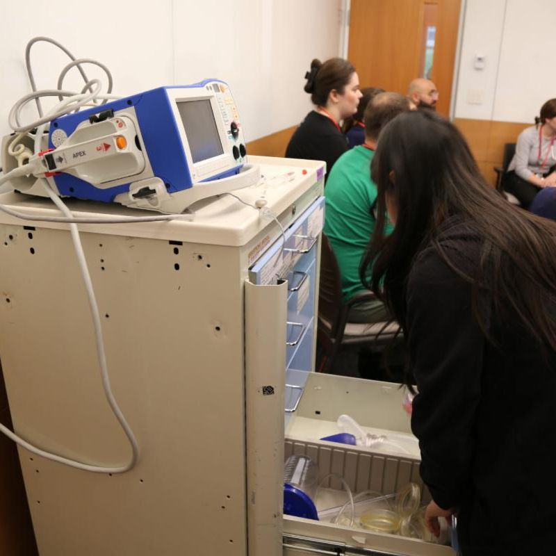 Researcher demo-ing an early prototype of the robotic medical crash cart.