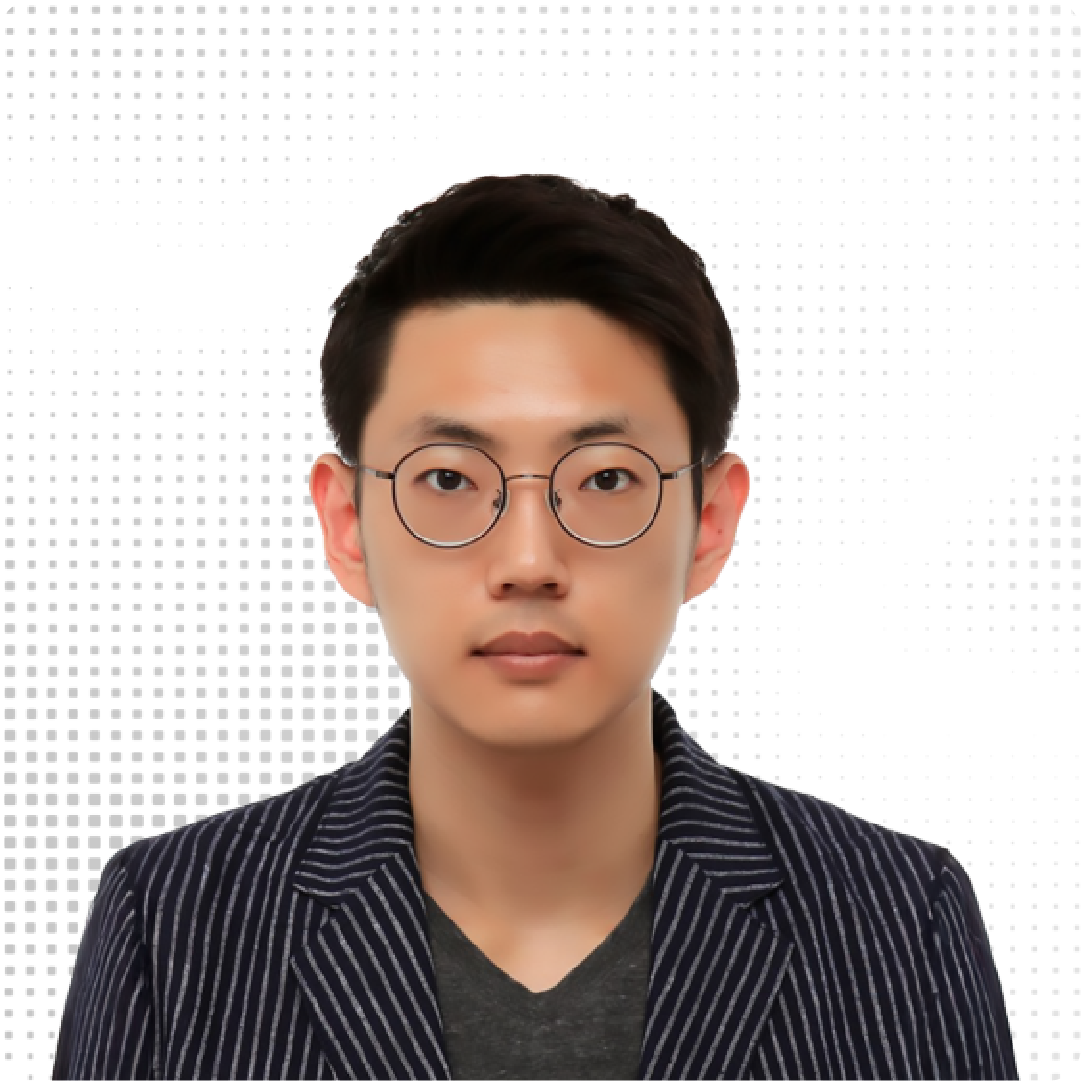 A color photo of a man smiling for a photo with a blurred background