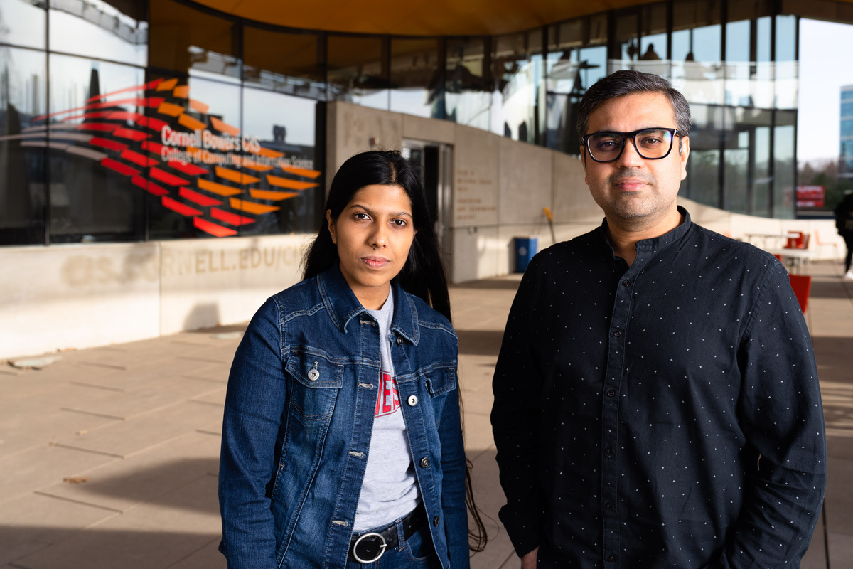 A color photo of a man and woman standing outside
