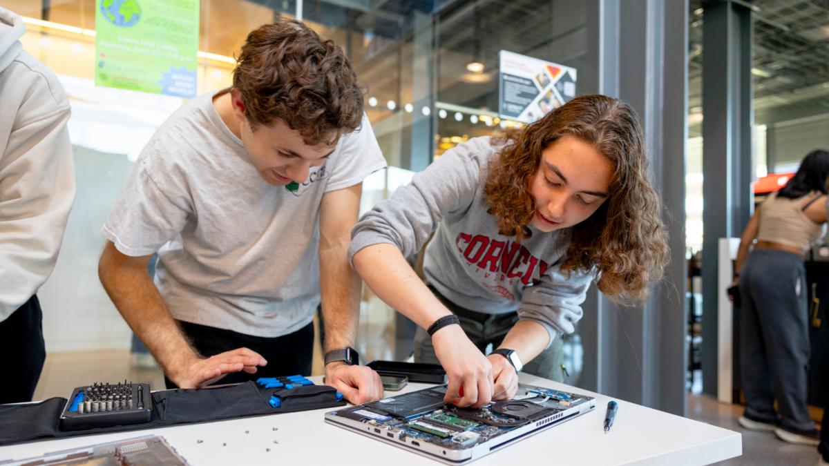 Volunteers fix a laptop at last year’s Bowers Earth Day Repair Fair in Gates Hall. (photo by Noël Heaney)