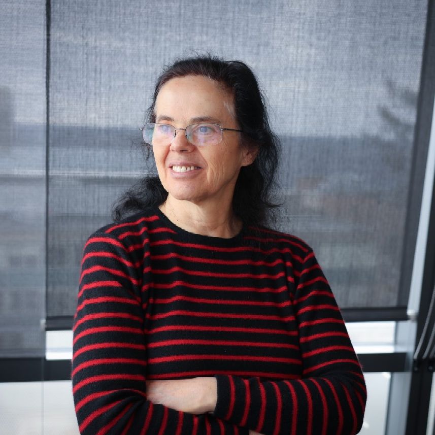 A color photo of a woman smiling for a photo