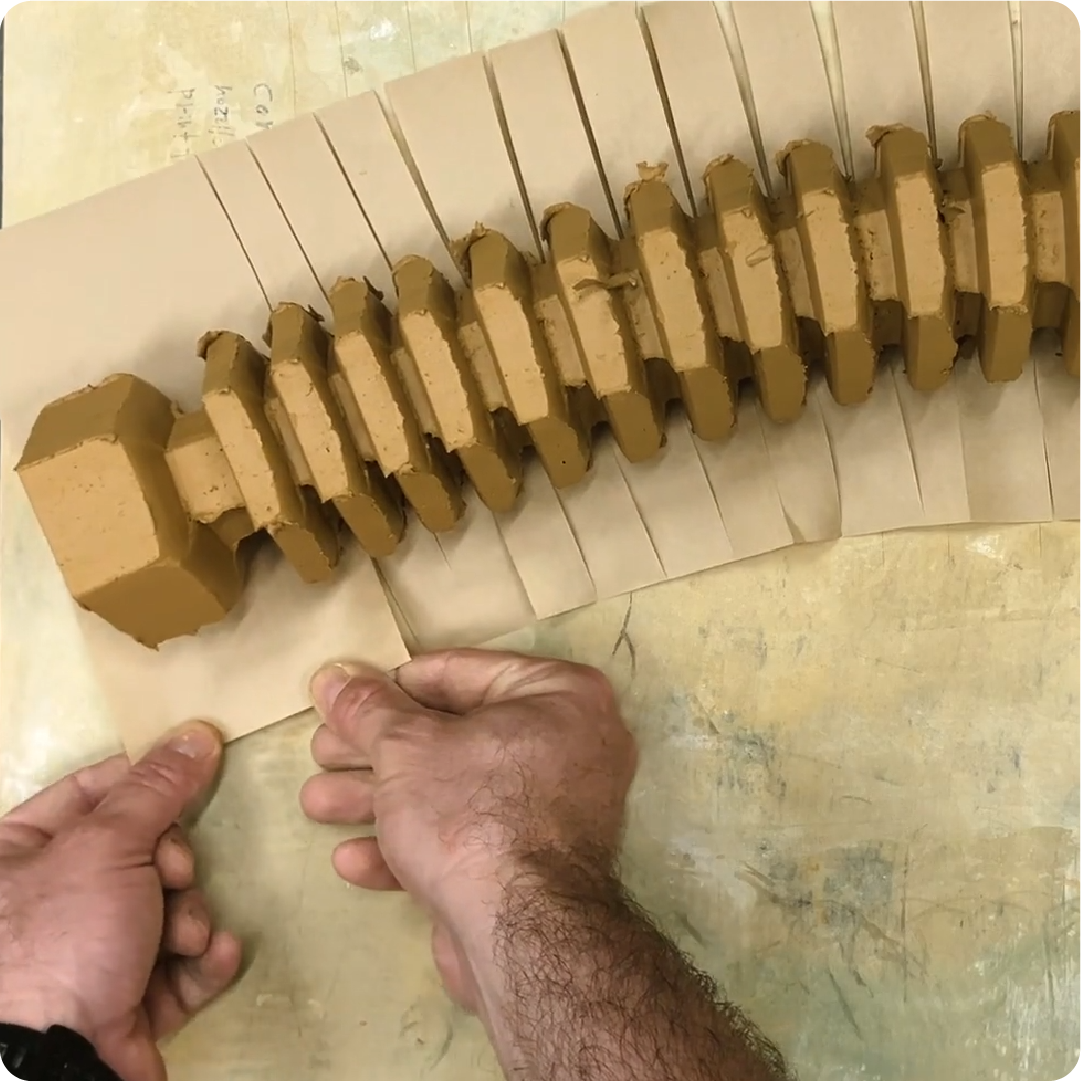 A color photo showing hands working on a project.