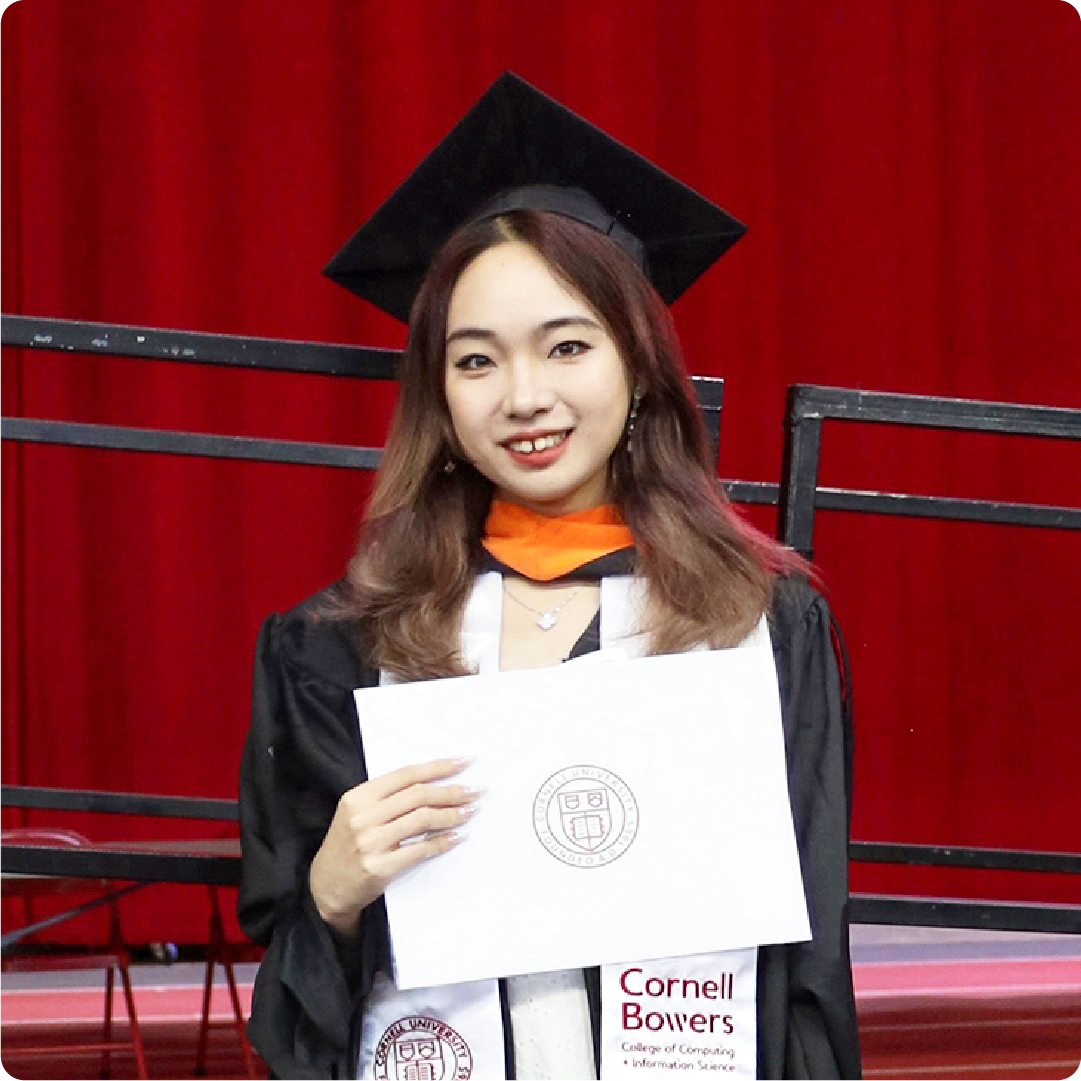 A color photo of a woman after graduation with her degree.