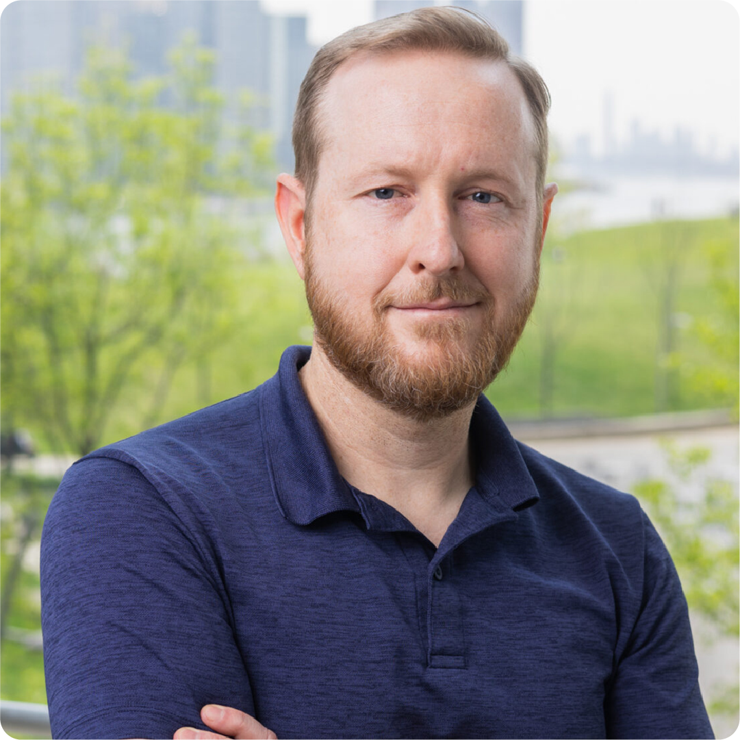 A color photo of a man smiling for a photo.
