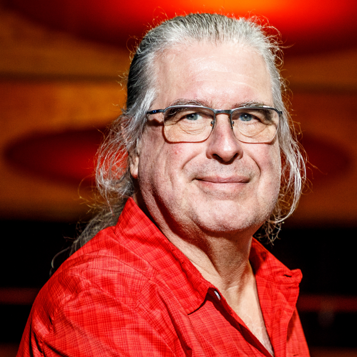 A color photo of a man smiling for a photo.
