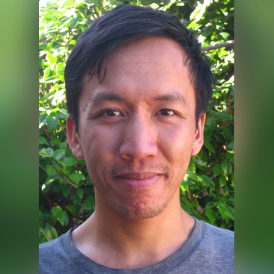 A color photo of a man smiling for a photo