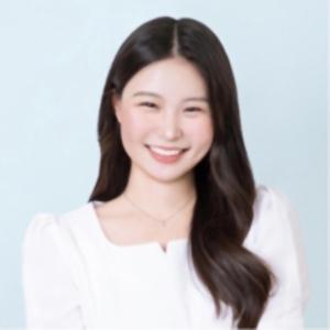 A color photo of a woman smiling for a photo