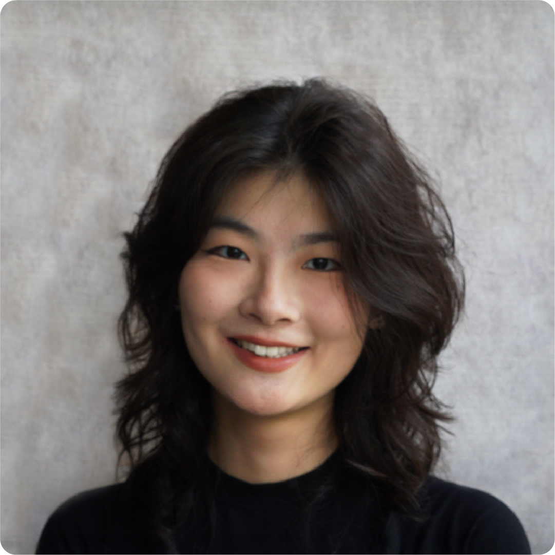 A color photo of a woman smiling for a photo