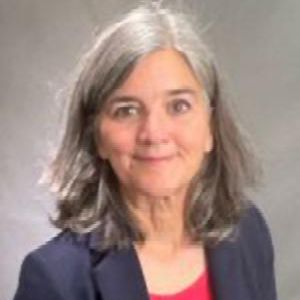 A color photo of a woman smiling for a photo