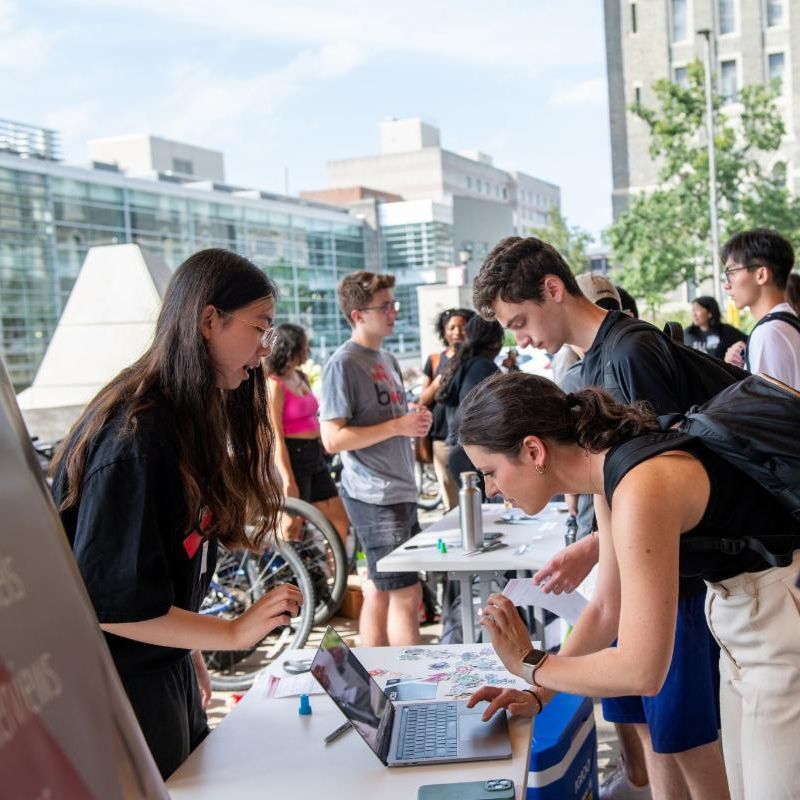 A color photo showing students at the 2023 Cornell Bowers Academic Fair