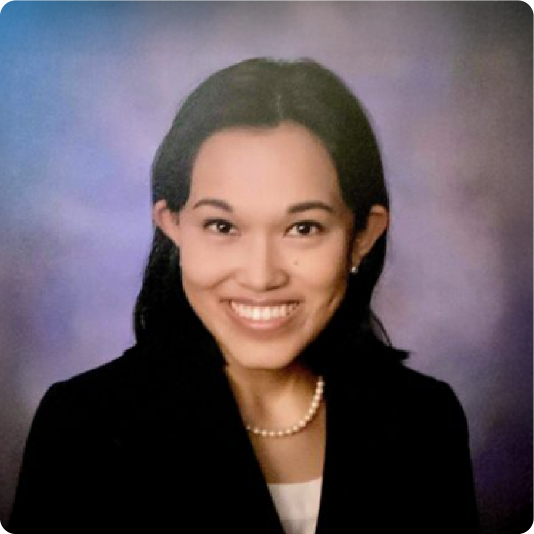 A color photo of a woman smiling for a photo