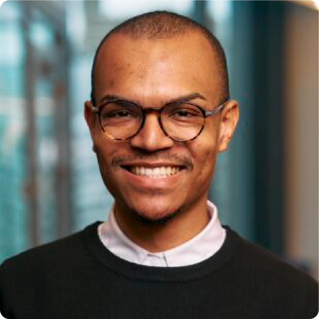 A color photo of a man smiling for a photo.