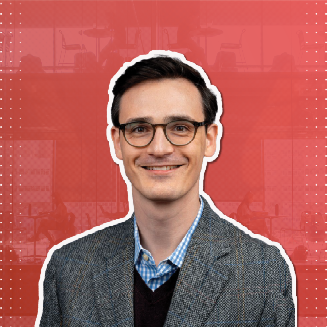 A color photo of a man smiling for a photo