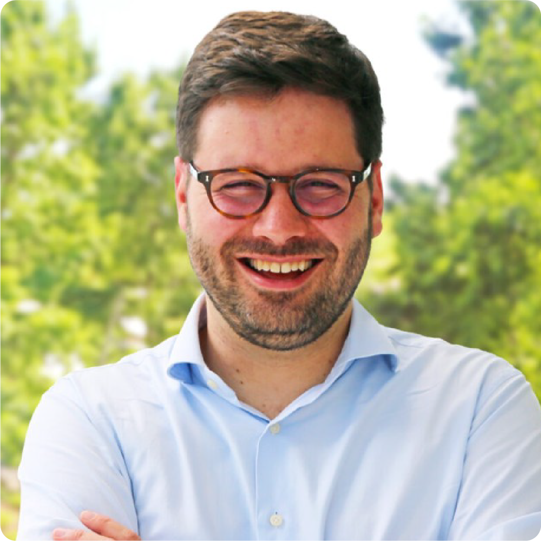 A color photo of a man smiling for a photo