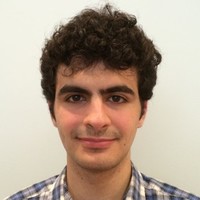 A color photo of a man smiling for a photo