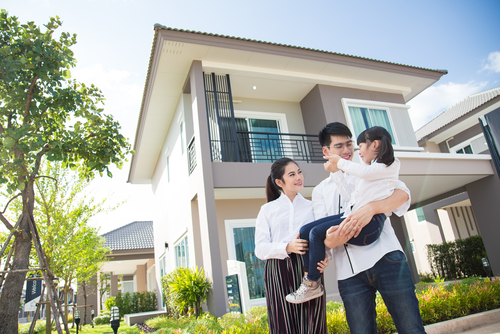 Asian family Happy Daughter pointing parents to look after her _ with child over house background.
