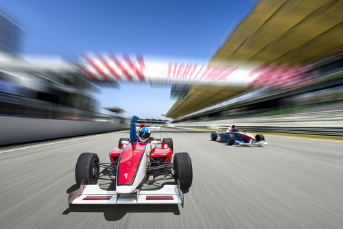 driver celebrate victory pass the finishing point and Race car racing on a track with motion blur.