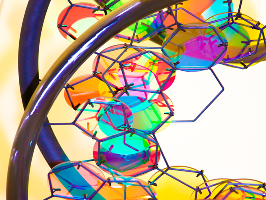 Closeup photo of DNA sculpture's colorful glass hexagons and metal rods