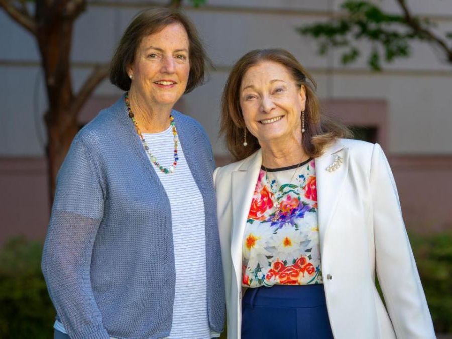 Two women standing outside smiling