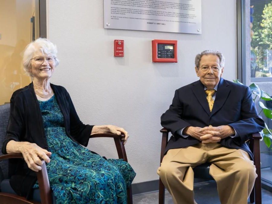 Two people nicely dressed and sitting in a lobby