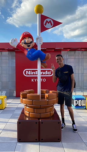 UToledo political science student Antoine Washington in front of a Nintendo display in Japan
