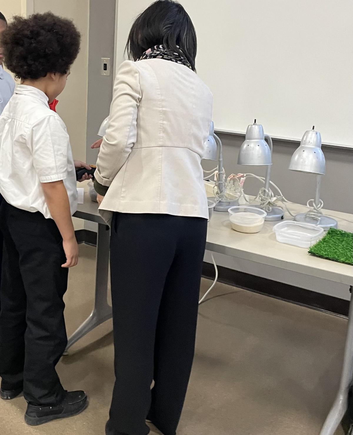 TPS student and teacher at adisplay during the STEM and Geography Workshop