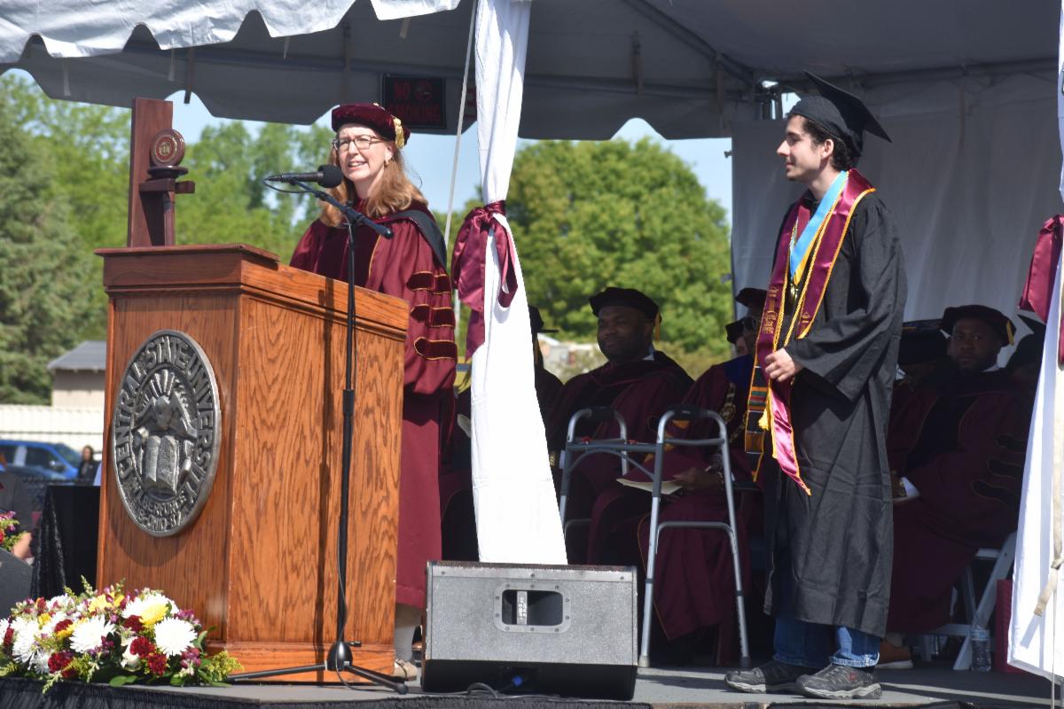 amy hobbs harris and tristin fernandes on stage at commencement