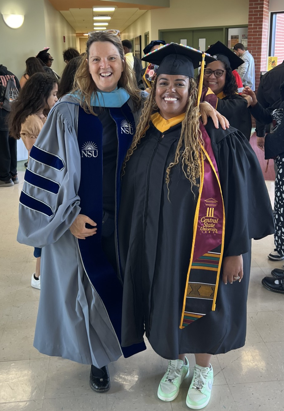 two people in graduation regalia