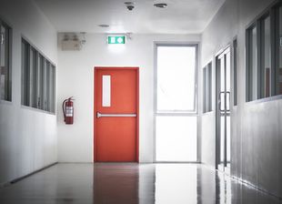 Building Emergency Exit with Exit Sign on door and Fire Extinguisher