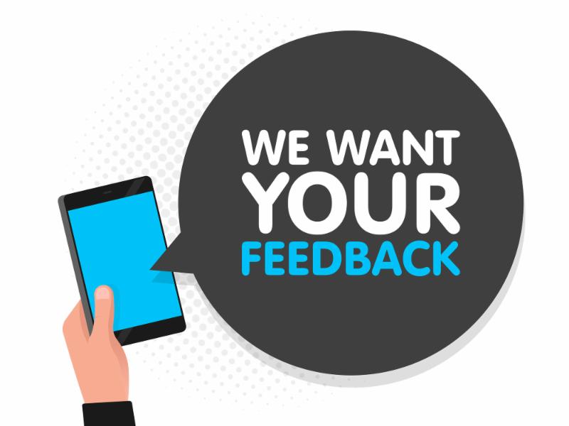 hand holding phone with words WE WANT YOUR FEEDBACK