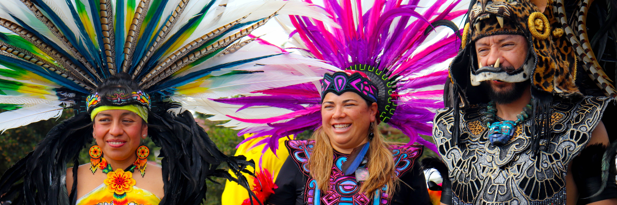 Aztec Dance performers smile for a photo outdoors