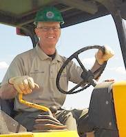 Park Manager Eric Goodrich drives a tractor on Cottle Ranch. 
Photo by Ron Horii