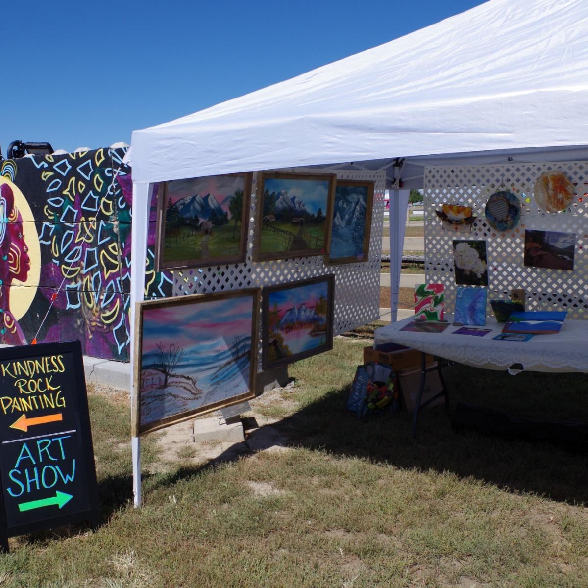 Picture of a tent with art displayed.