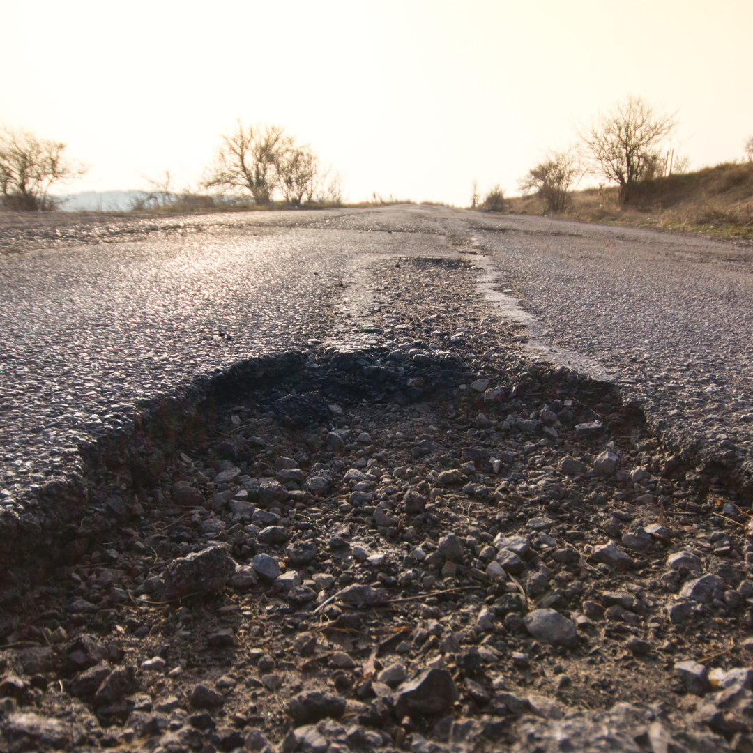 A graphic of a pothole in the middle of the roadway