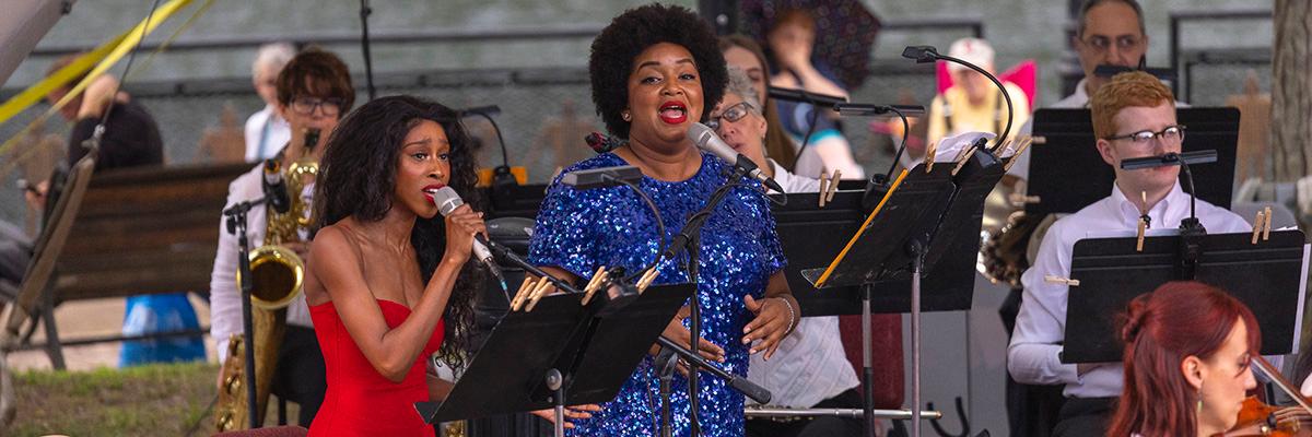 Two women perform with the Albany Symphony Orchestra at a concert along the Erie Canal.