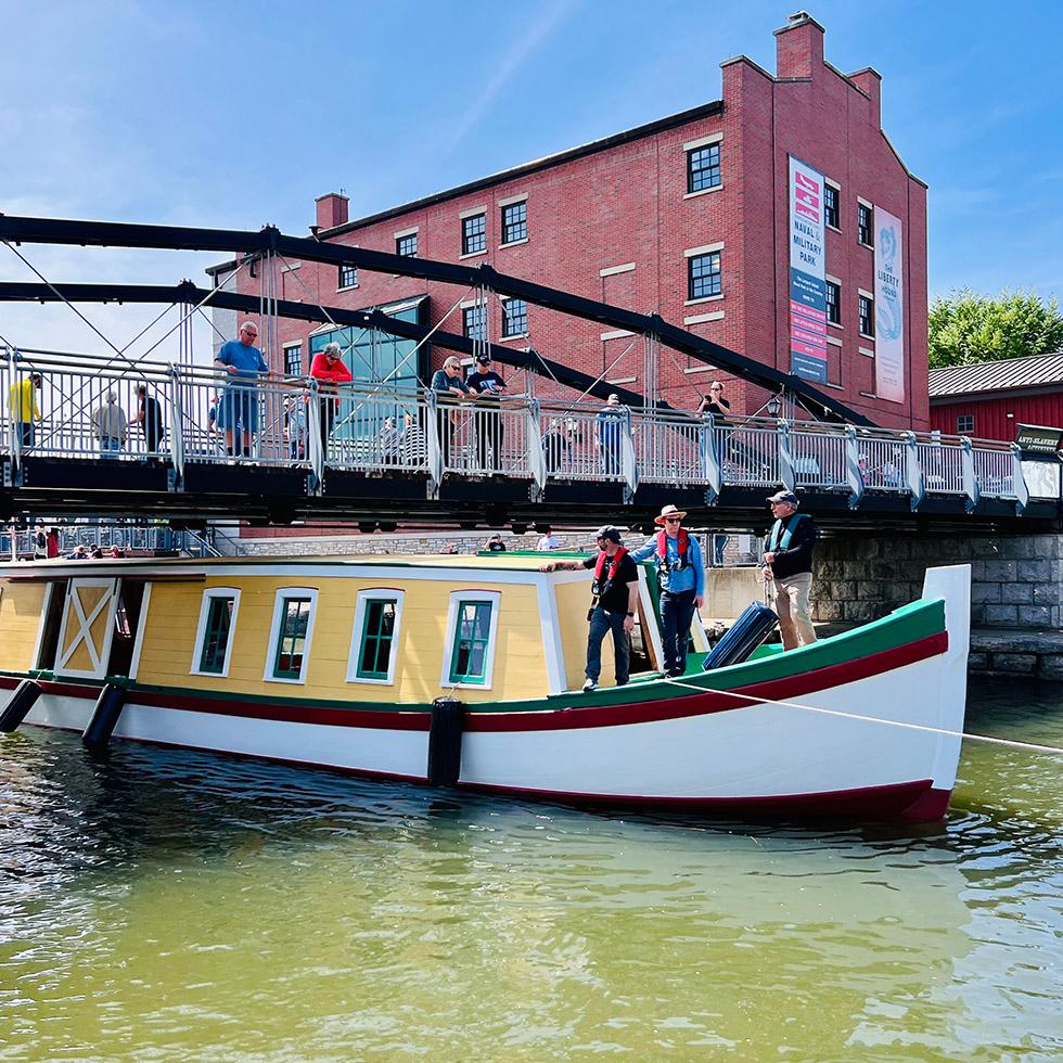 The canal boat Seneca Chief passing under a low bridge
